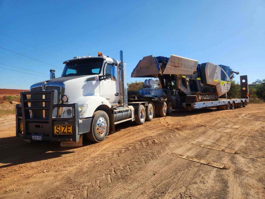 Heavy haulage crusher transporting bulk materials across regional WA