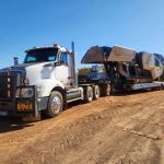 Heavy haulage crusher transporting bulk materials across regional WA