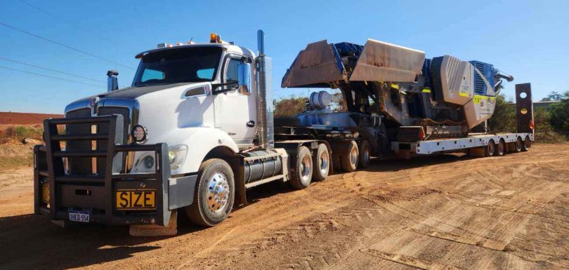 Heavy haulage crusher transporting bulk materials across regional WA